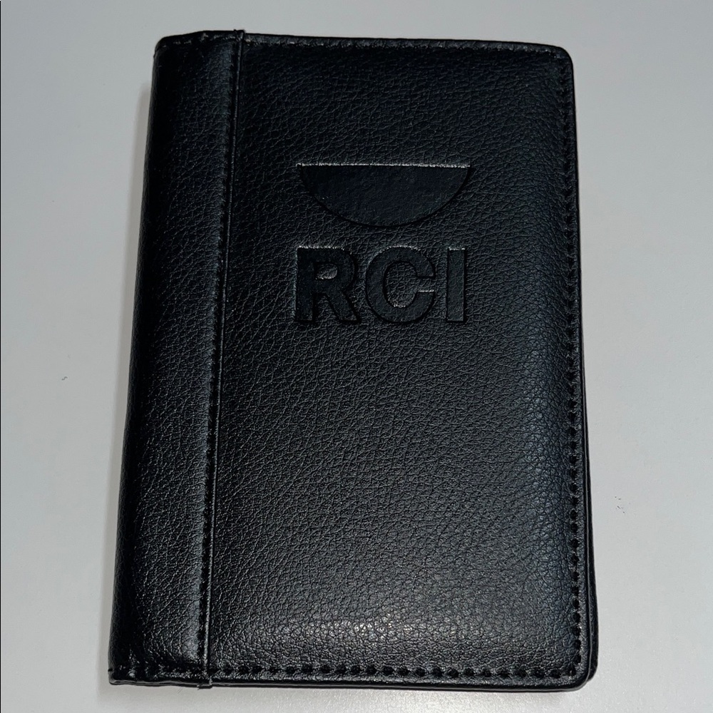RCI black leather passport holder. 4 1/4”L X 5 1/2” H.